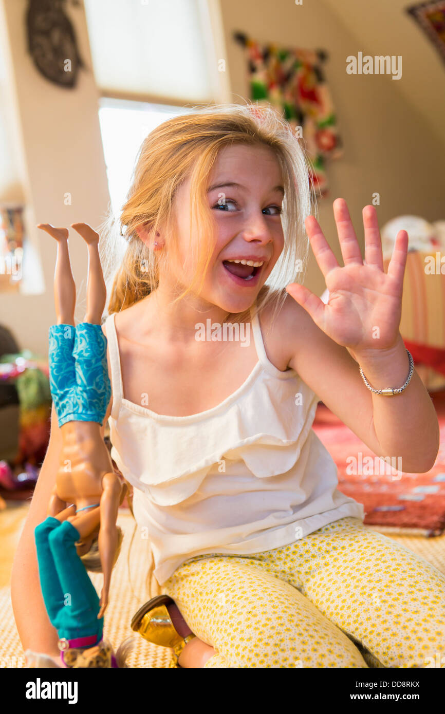 Caucasian girl playing with dolls Stock Photo