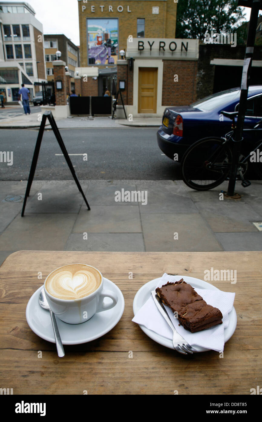 Cappuccino and chocolate brownie served at Store Street Espresso, Bloomsbury, London, UK Stock Photo