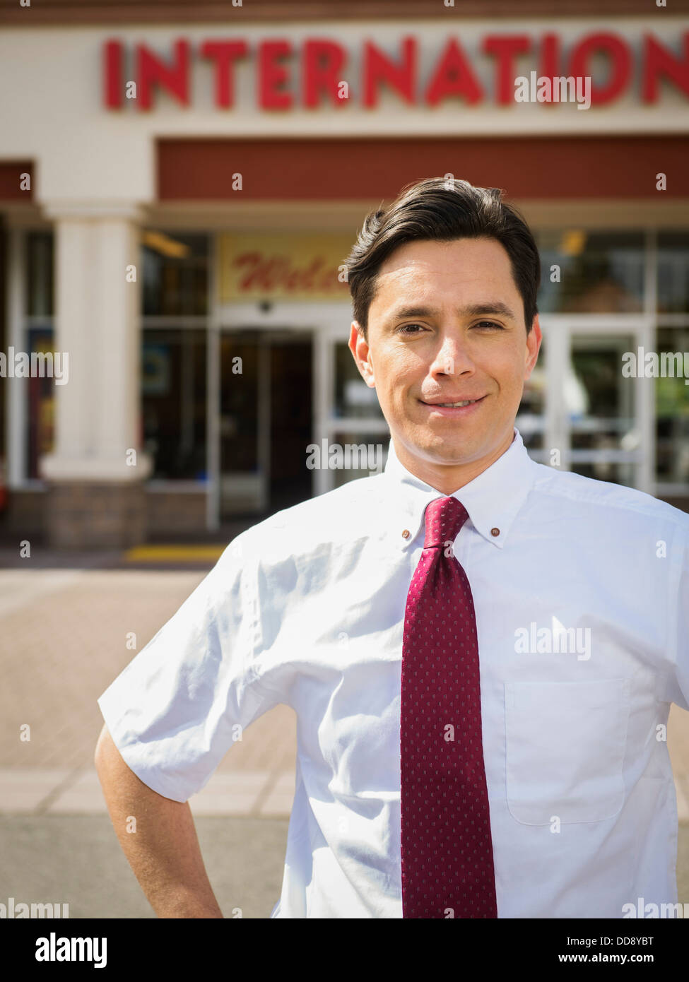 Hispanic businessman standing outside grocery store Stock Photo Alamy