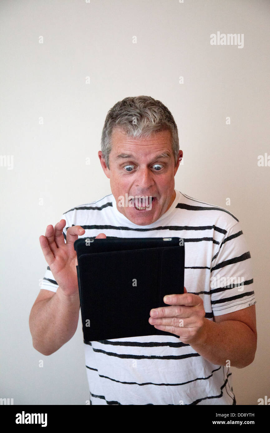 Excited man with Ipad Tablet Stock Photo