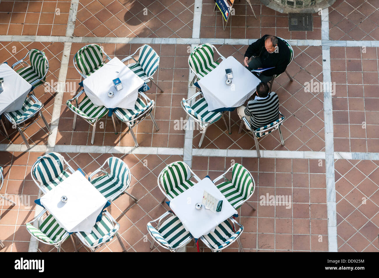 Man at estaurant tables and chairs, Mijas, Spain Stock Photo