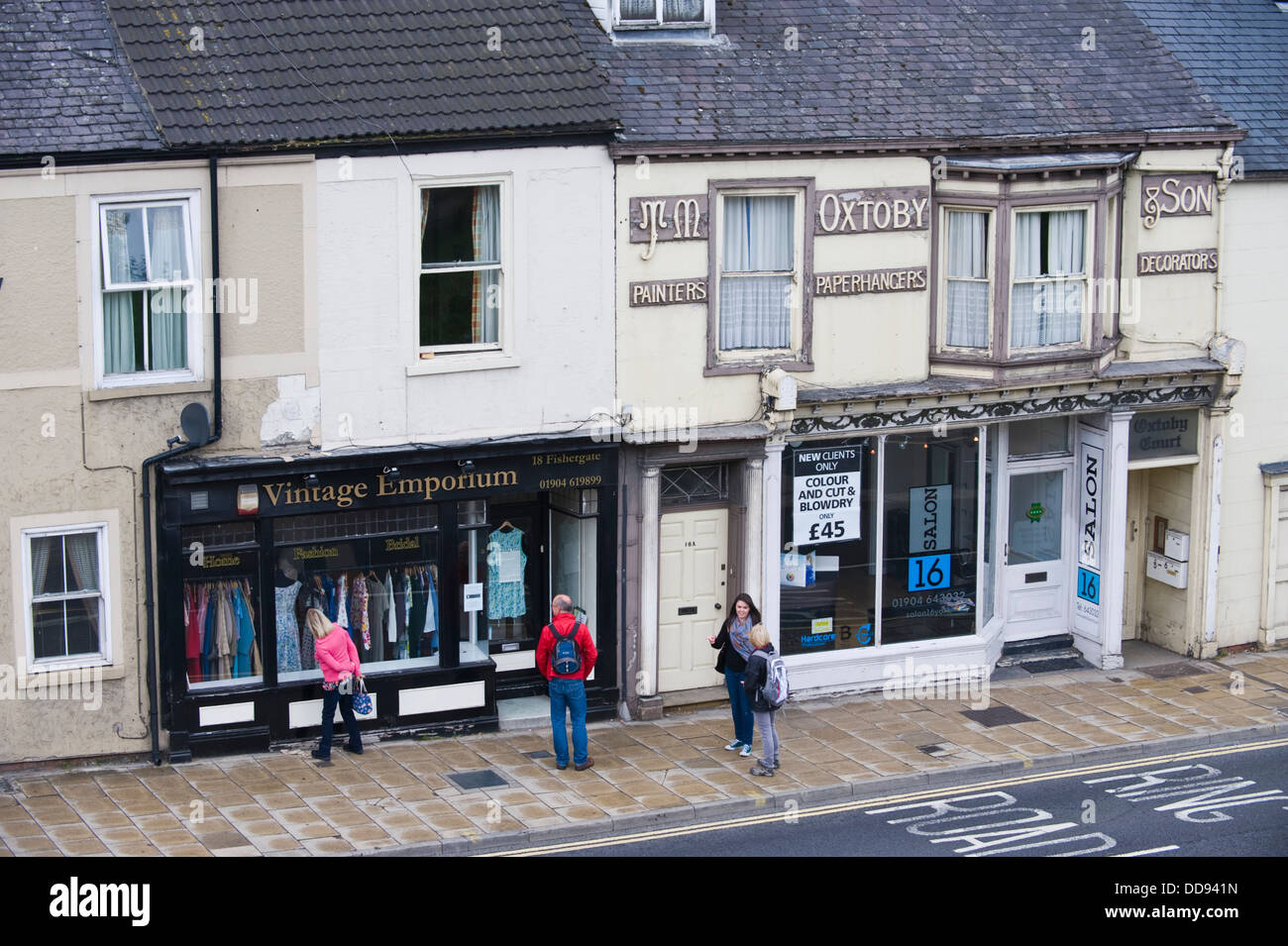 Row of local shops at Fishergate in city of York North Yorkshire England UK Stock Photo