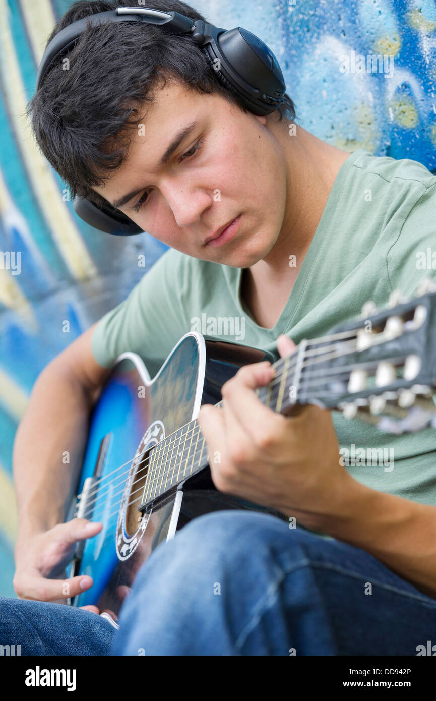 Hispanic man playing guitar Stock Photo
