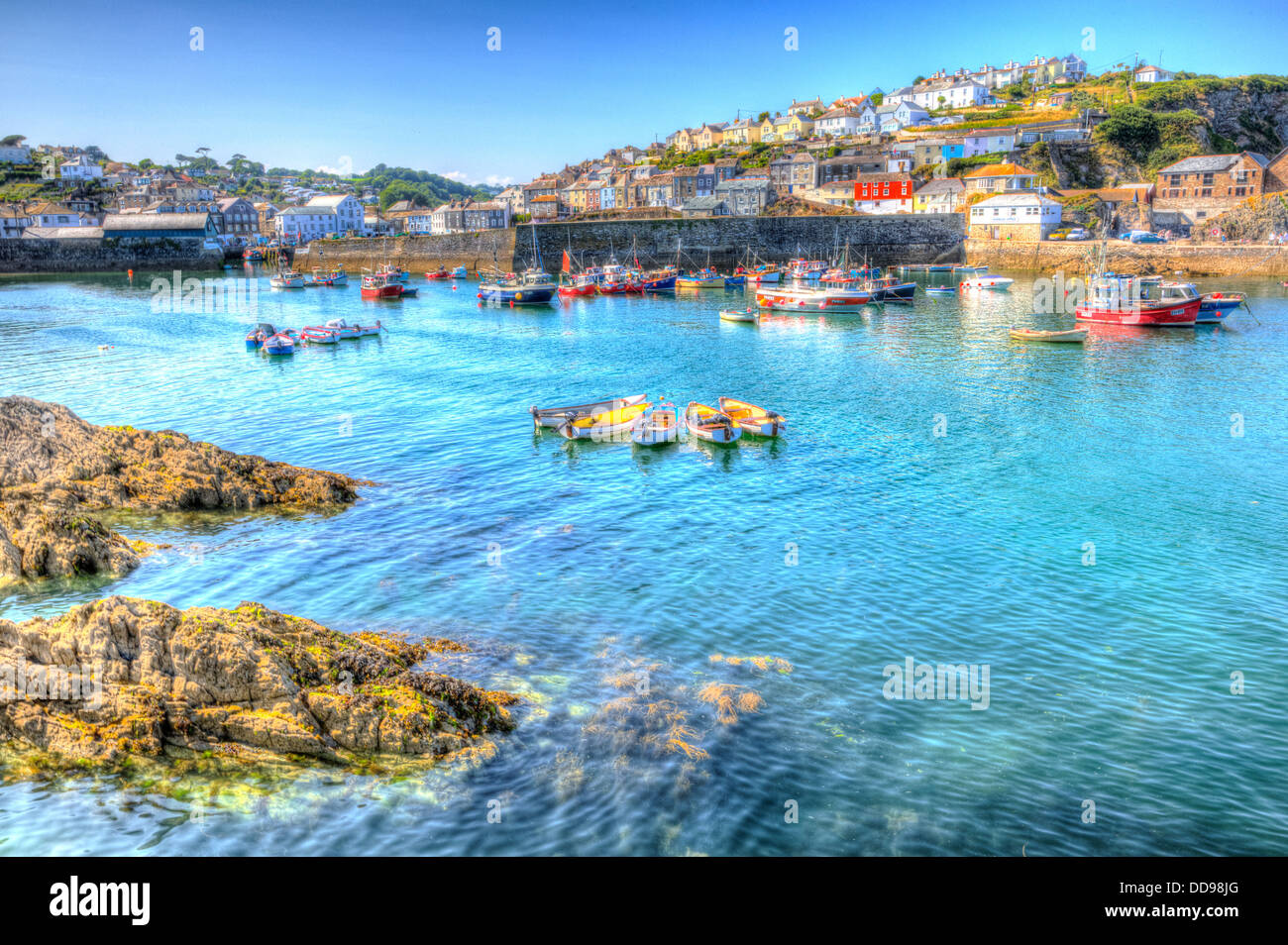 Mevagissey Cornwall with boats in the harbour stunning blue sea and sky.  HDR image in England UK Stock Photo