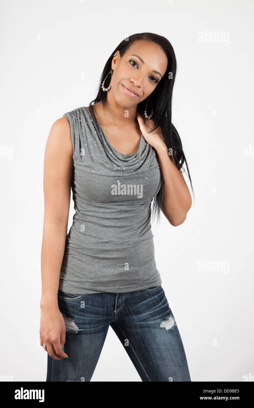 Pretty black woman standing and looking at the camera with a big, happy ...
