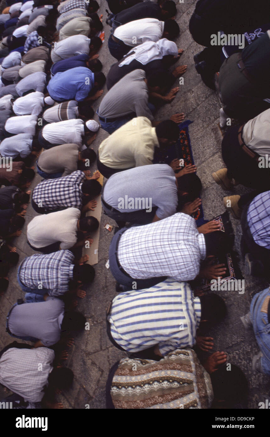 Muslim men performing the Ruku bowing during the Salah prayer in the Old City Jerusalem Israel Stock Photo