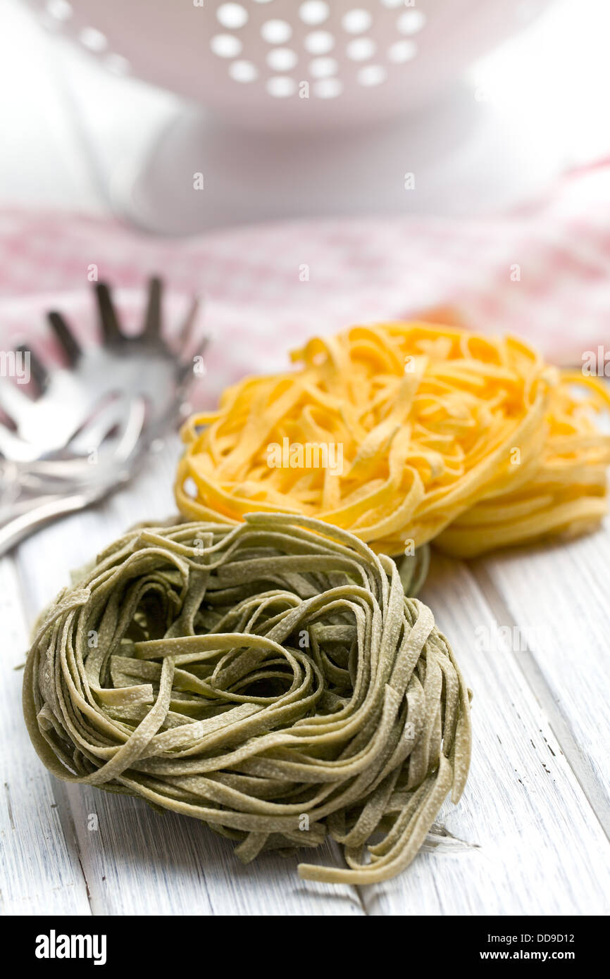 Italian pasta tagliatelle on wooden table Stock Photo