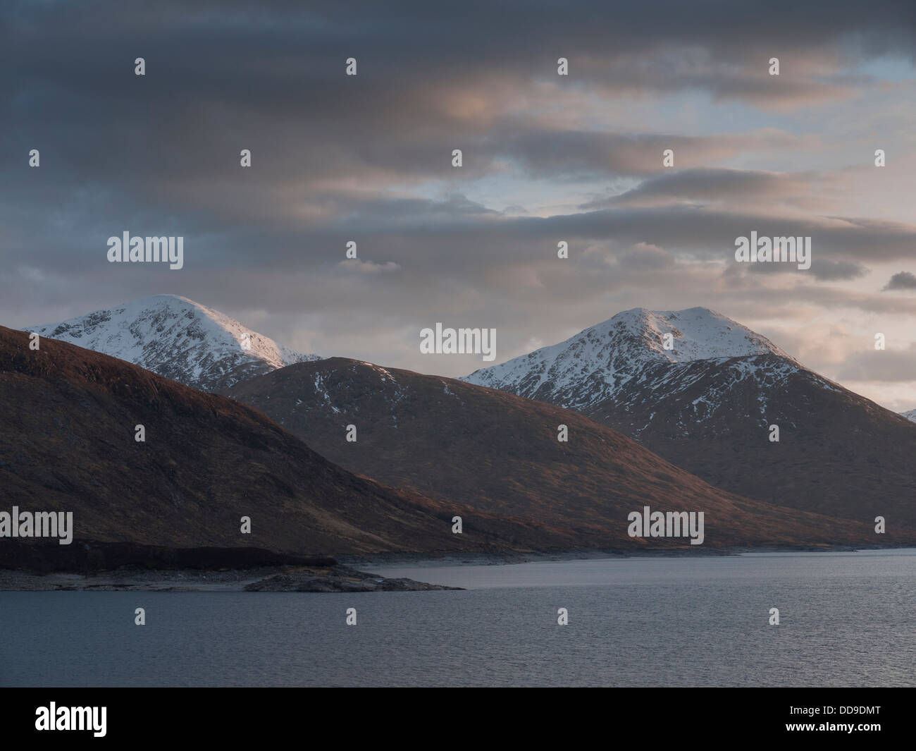 The view across Loch Quoich towards the mountains Sgurr Mor and Sgurr na Fhuarain at sunset, North West Highlands, Scotland, UK Stock Photo