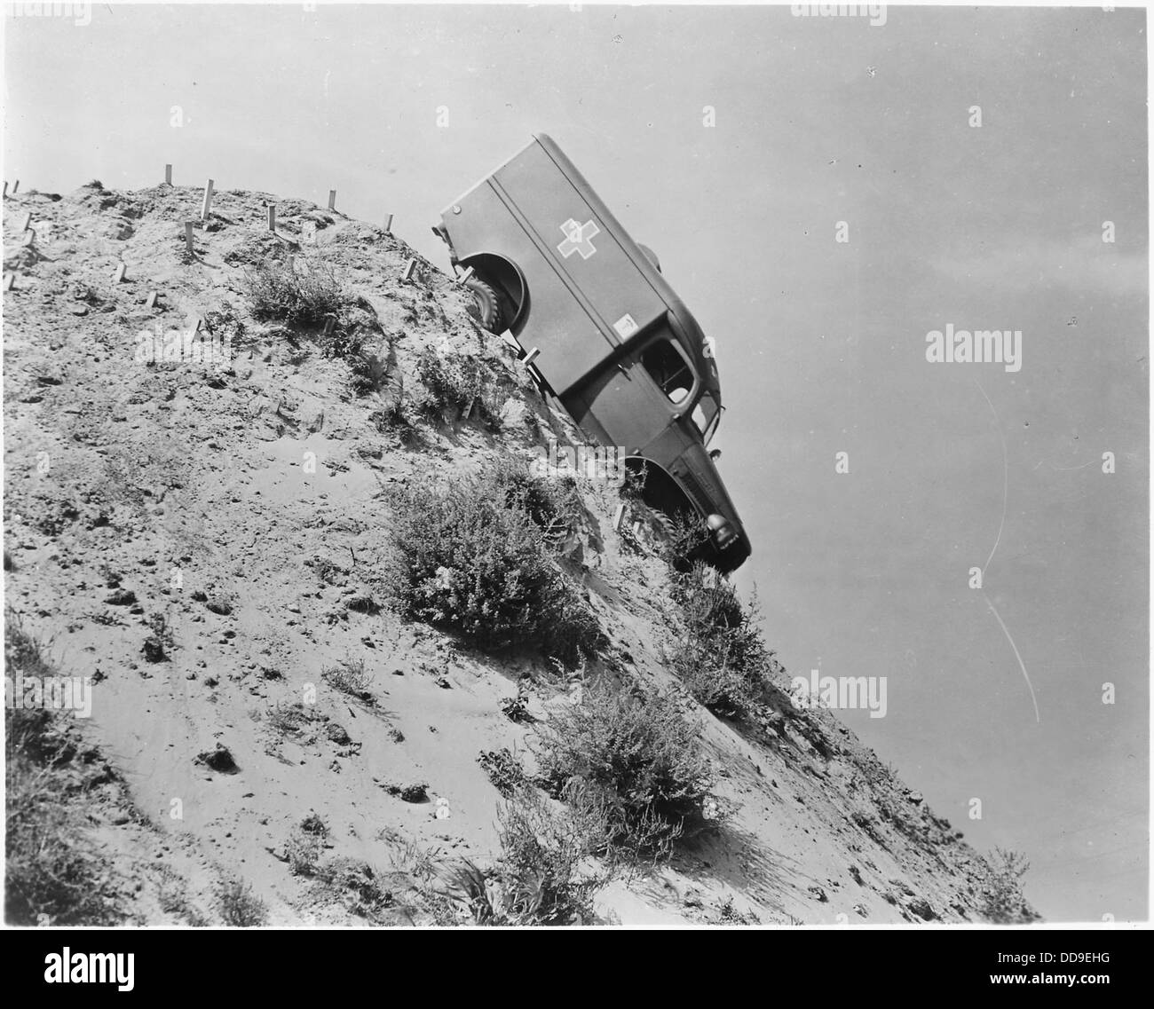 Here an Army ambulance takes a nose-dive down the almost perpendicular side of a high and tremendously steep hill... - - 196219 Stock Photo