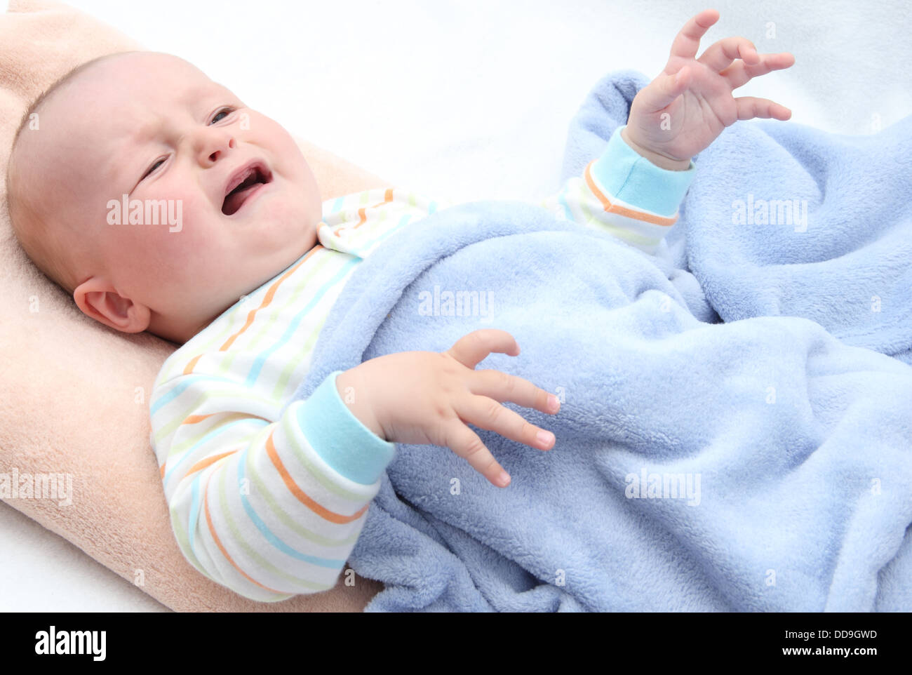 little baby crying in bed Stock Photo