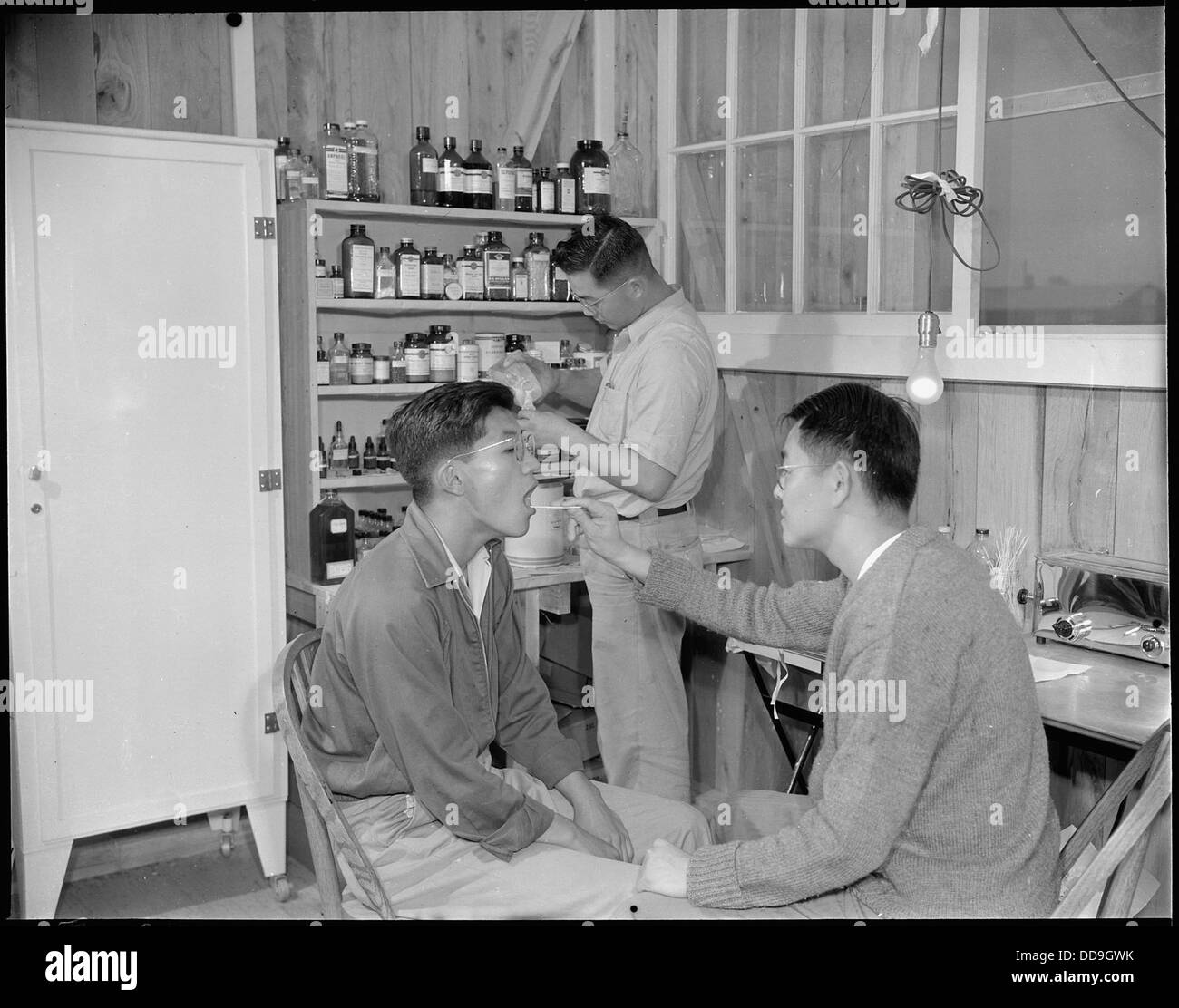 Jerome Relocation Center, Denson, Arkansas. A patient, teacher of high school science, being examin . . . - - 538864 Stock Photo