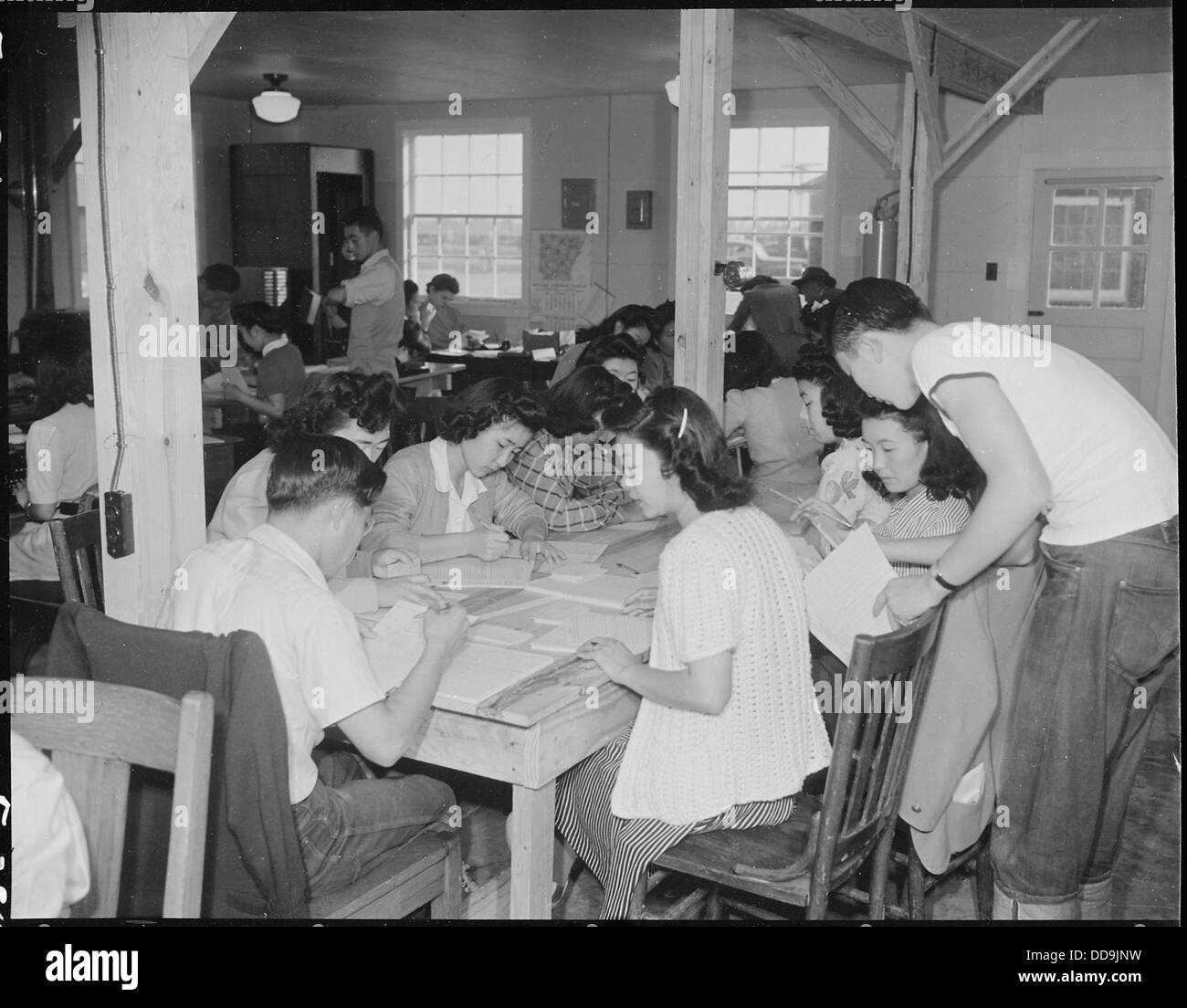 At the Jerome Relocation Center in Denson, Arkansas, evacuees are shown ...