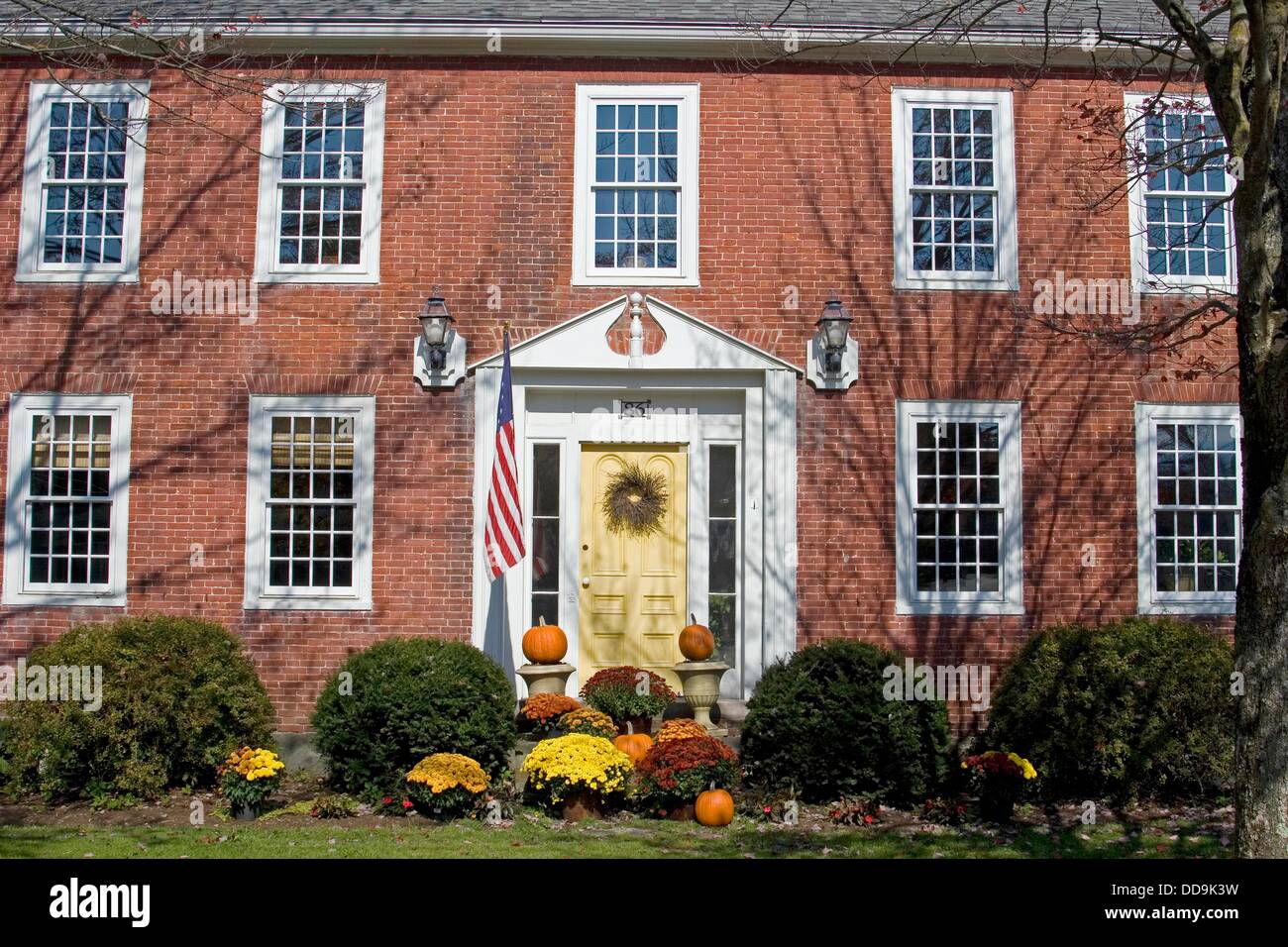 Cambridge Vermont red brick house decorated with fall foliage, New