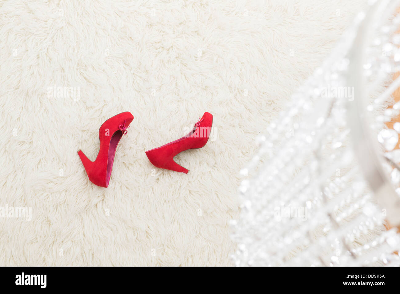 Red High Heels laying on white carpet Stock Photo