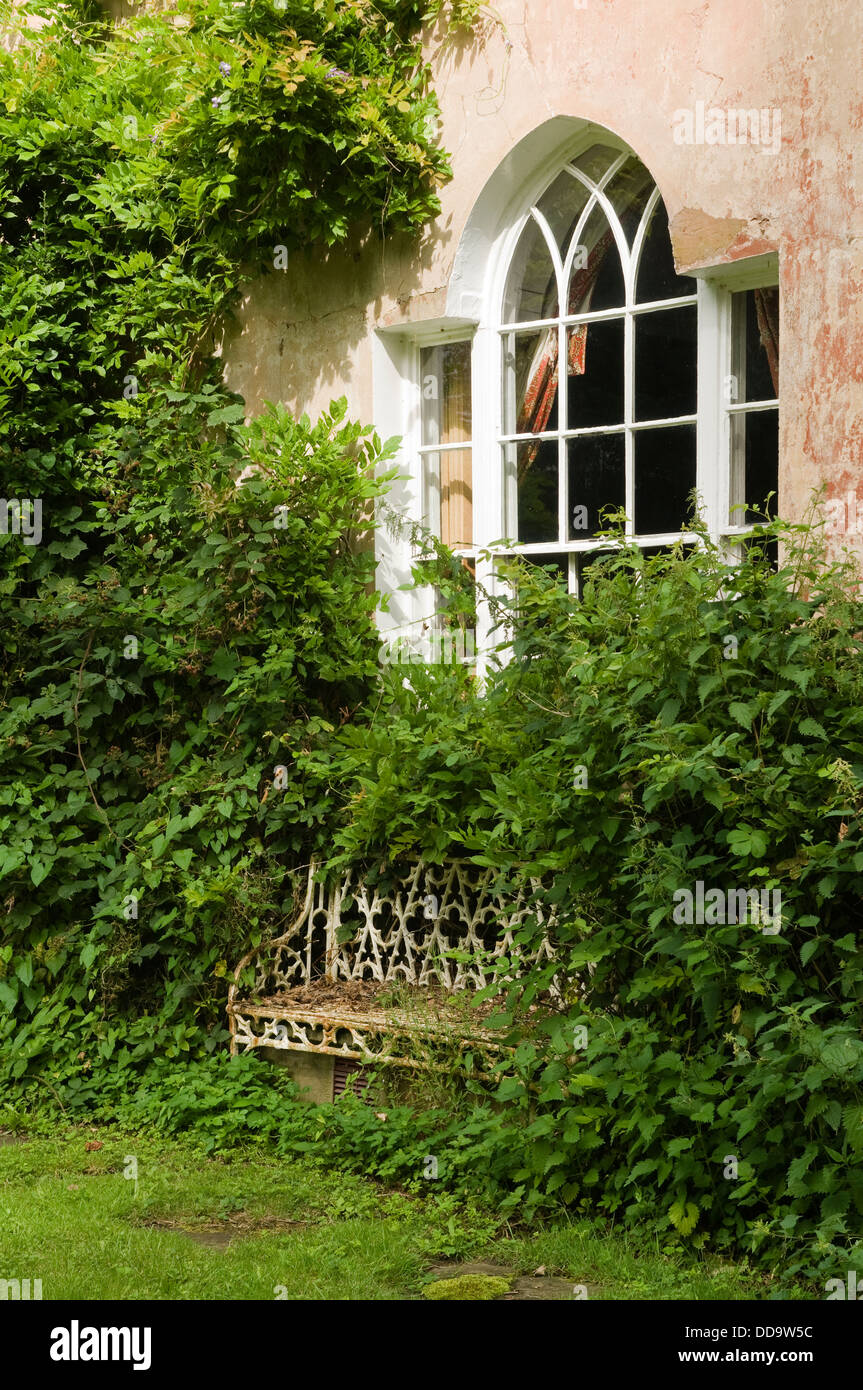 Cast iron seating in grounds of 18th century Sussex home Stock Photo