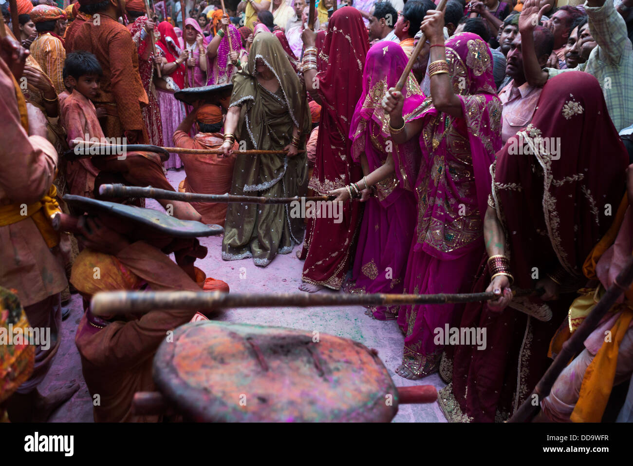 At Barsana Holi in a traditional confrontation, a women's group hit with bamboo sticks on the shields that protect men. Stock Photo