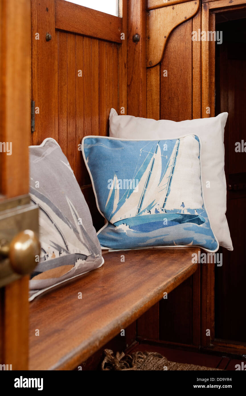 Cabin interior cushions on recessed wooden bench Stock Photo