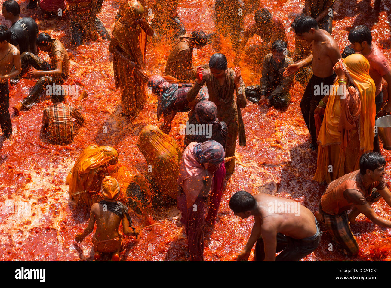 A group of people playing with the water stored inside the temple after the celebration of Holi in Baldeo. Stock Photo