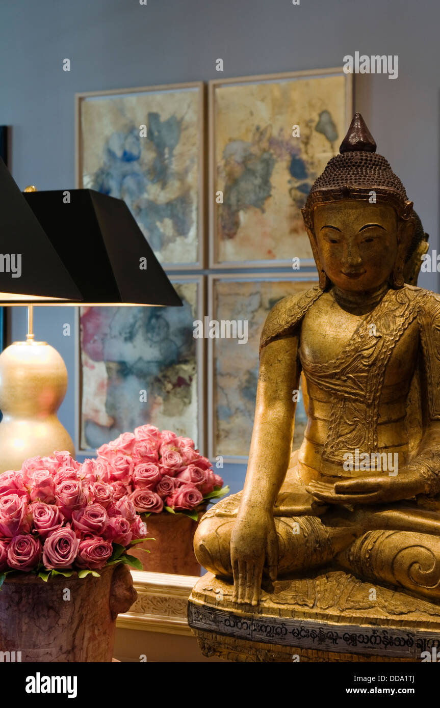Velvetcovered console table under large mirror reflecting four