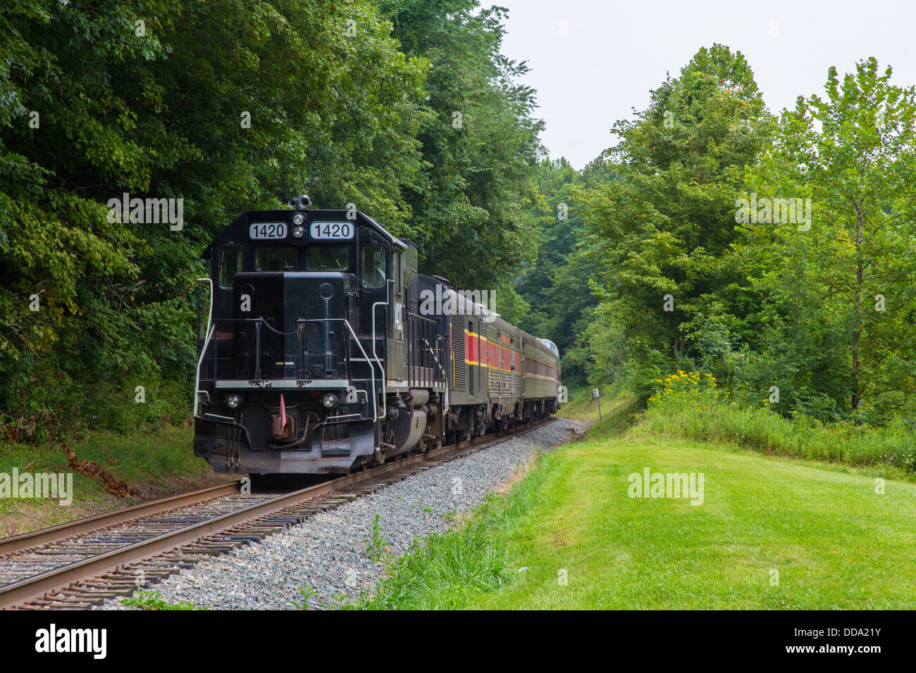 Train engine and passenger cars of Cuyahoga Valley Scenic Railroad though Cuyahoga Valley National Park in Ohio United States Stock Photo