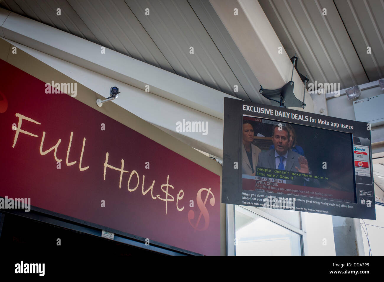 London, UK. 29th Aug, 2013 - Seen on a TV screen inside the Moto Services on the M4 motorway, near Heathrow airport, London England, Conservative MP, Dr Liam Fox speaks in favour of military action against the Assad government in Syria during an emergency debate in the House of Commons, the parliament of the United Kingdom, a pun on the term Full House - Copyright Richard Baker / Alamy Live News. Stock Photo