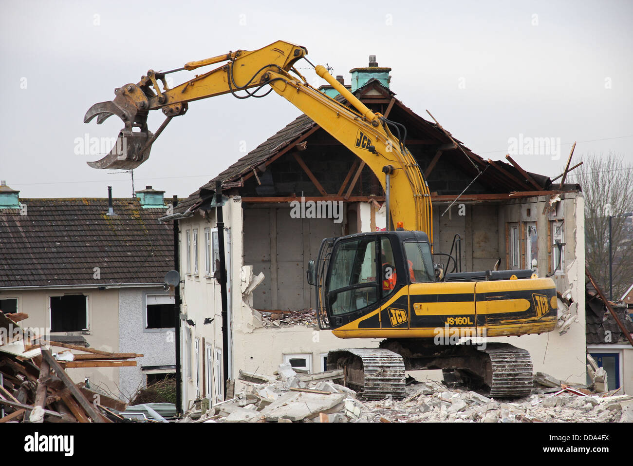A digger demolishes a house in Lockleaze, Bristol. Stock Photo