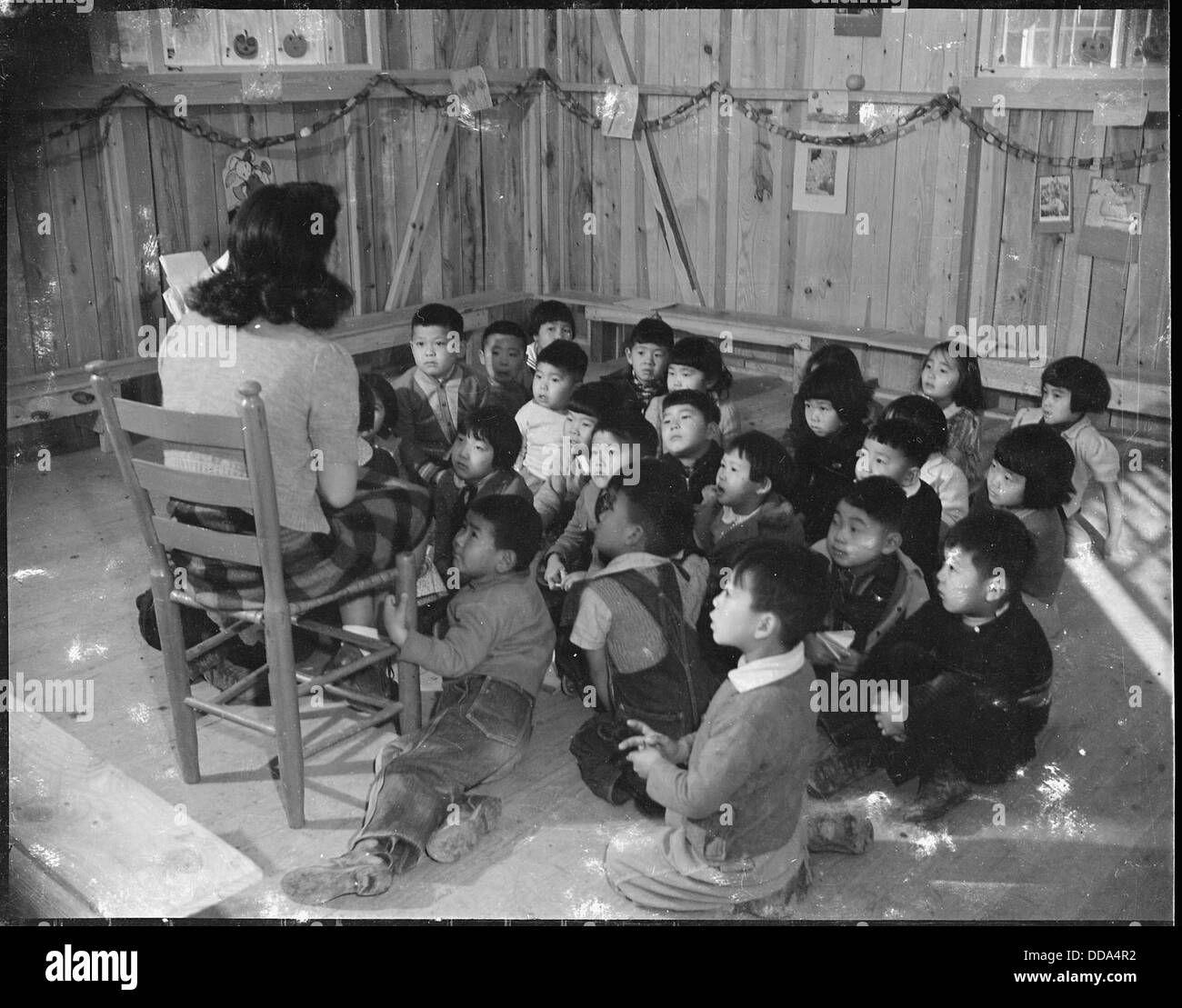 Rohwer Relocation Center, McGehee, Arkansas. Shigeko Tabuchi, teacher. Kindergarten class in barra . . . - - 538957 Stock Photo