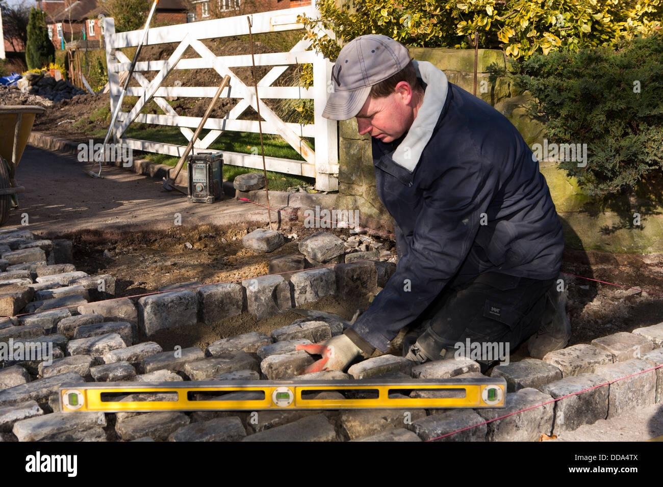self building house, hard landscaping, craftsman laying reclaimed