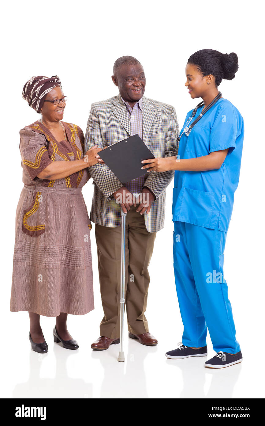 young female African nurse talking to senior couple isolated on white