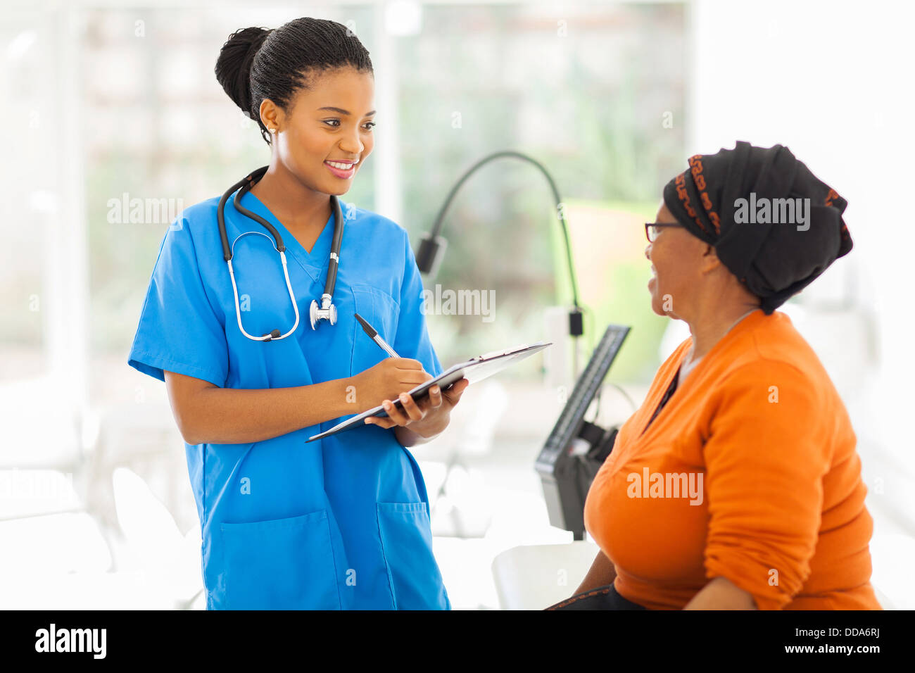 beautiful African medical nurse and senior patient Stock Photo