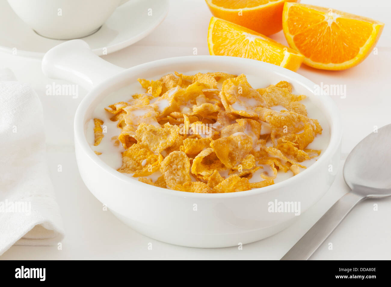 Cornflakes with Milk - a bowl of cornflakes with milk in a light bright setting. Stock Photo