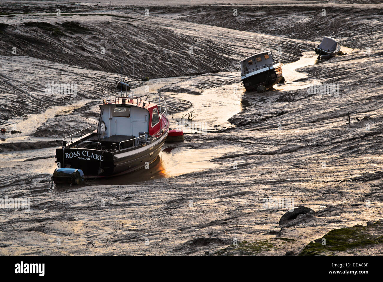 Boats beached on mud at The Pill near Clevedon - where the Blind Yeo meets the Bristol Channel Stock Photo