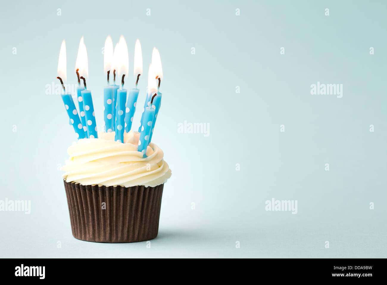 Cupcake decorated with birthday candles Stock Photo