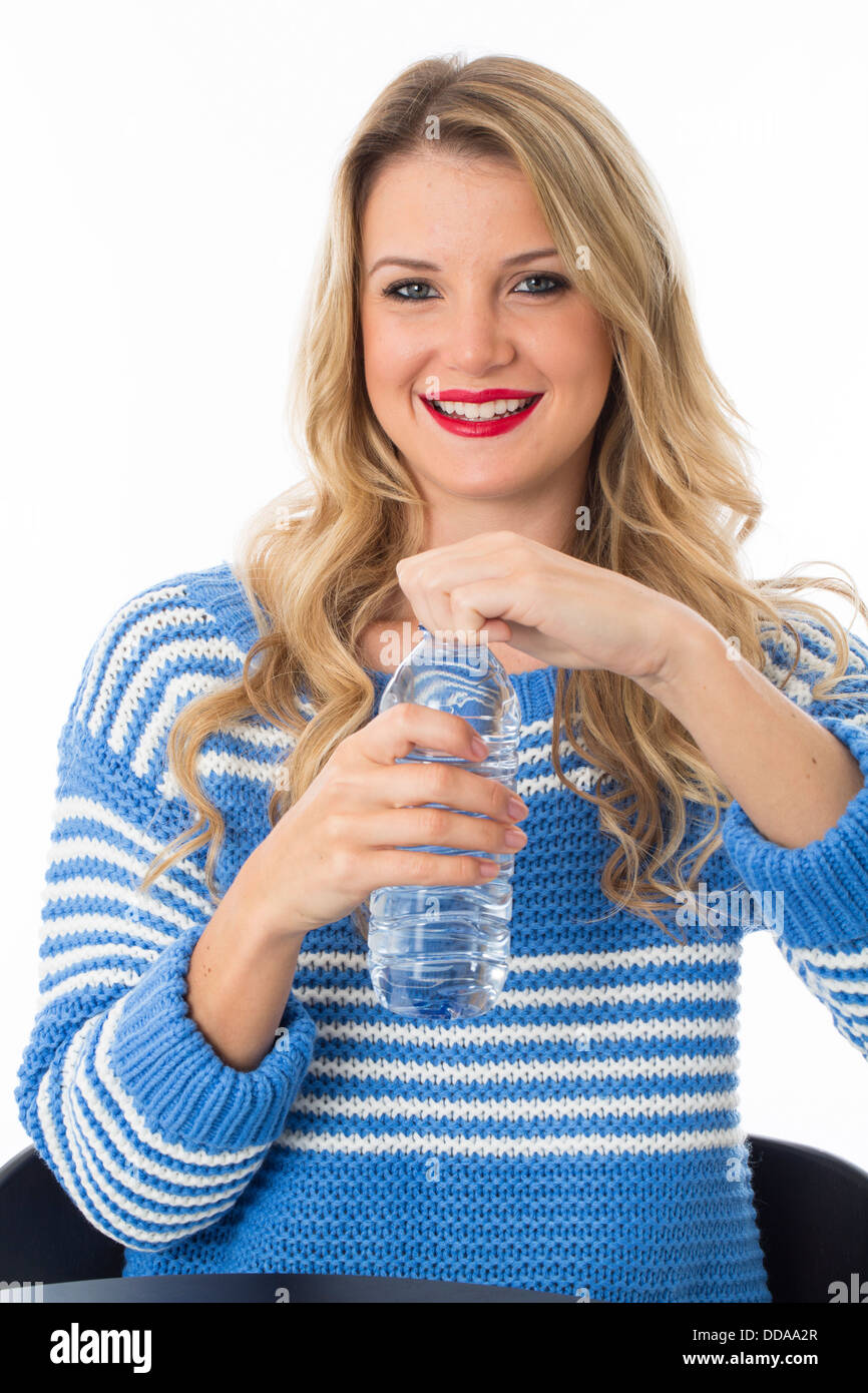 Healthy Confident Young Woman With A Plastic Bottle Of Still Fresh Refreshing Drinking Water Isolated Against A White Background With A Clipping Path Stock Photo