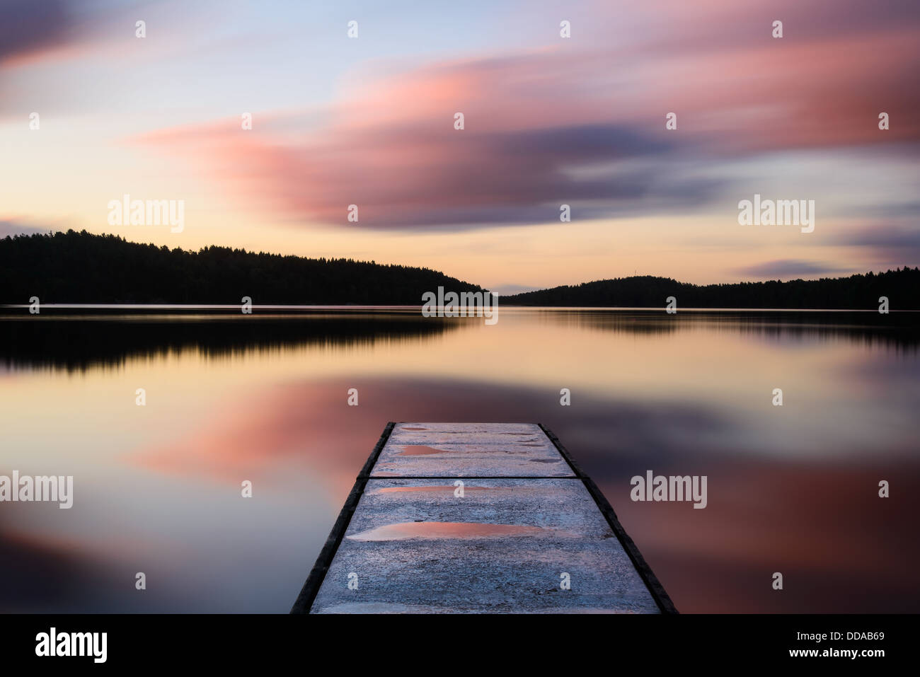 Jetty into lake at sunset, Stora Delsjön, Gothenburg, Sweden Stock Photo