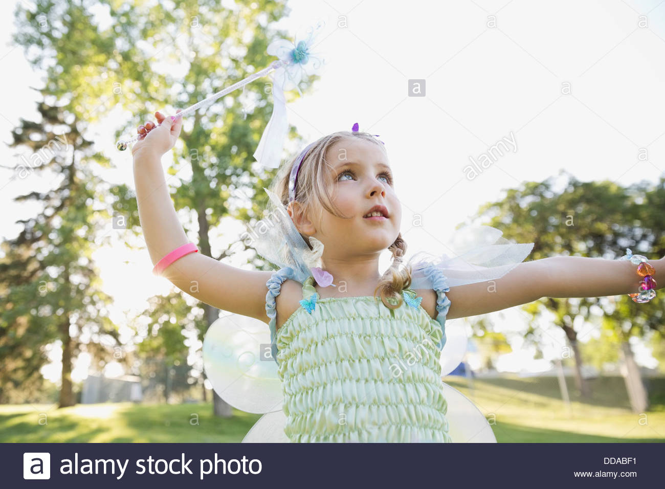 Little girl wearing fairy costume outdoors Stock Photo