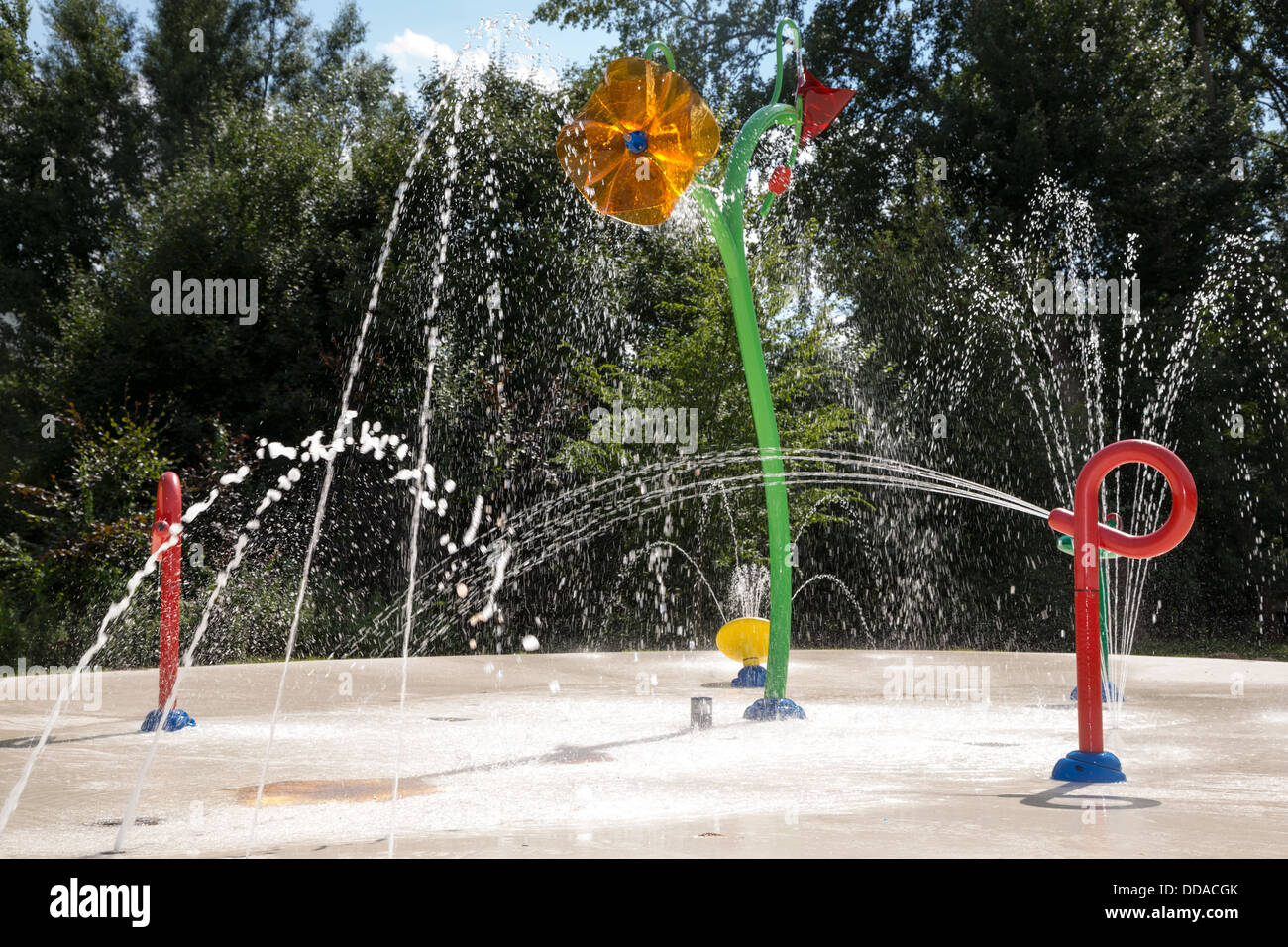 Water garden with trick fountains at public swimming pool Stock Photo