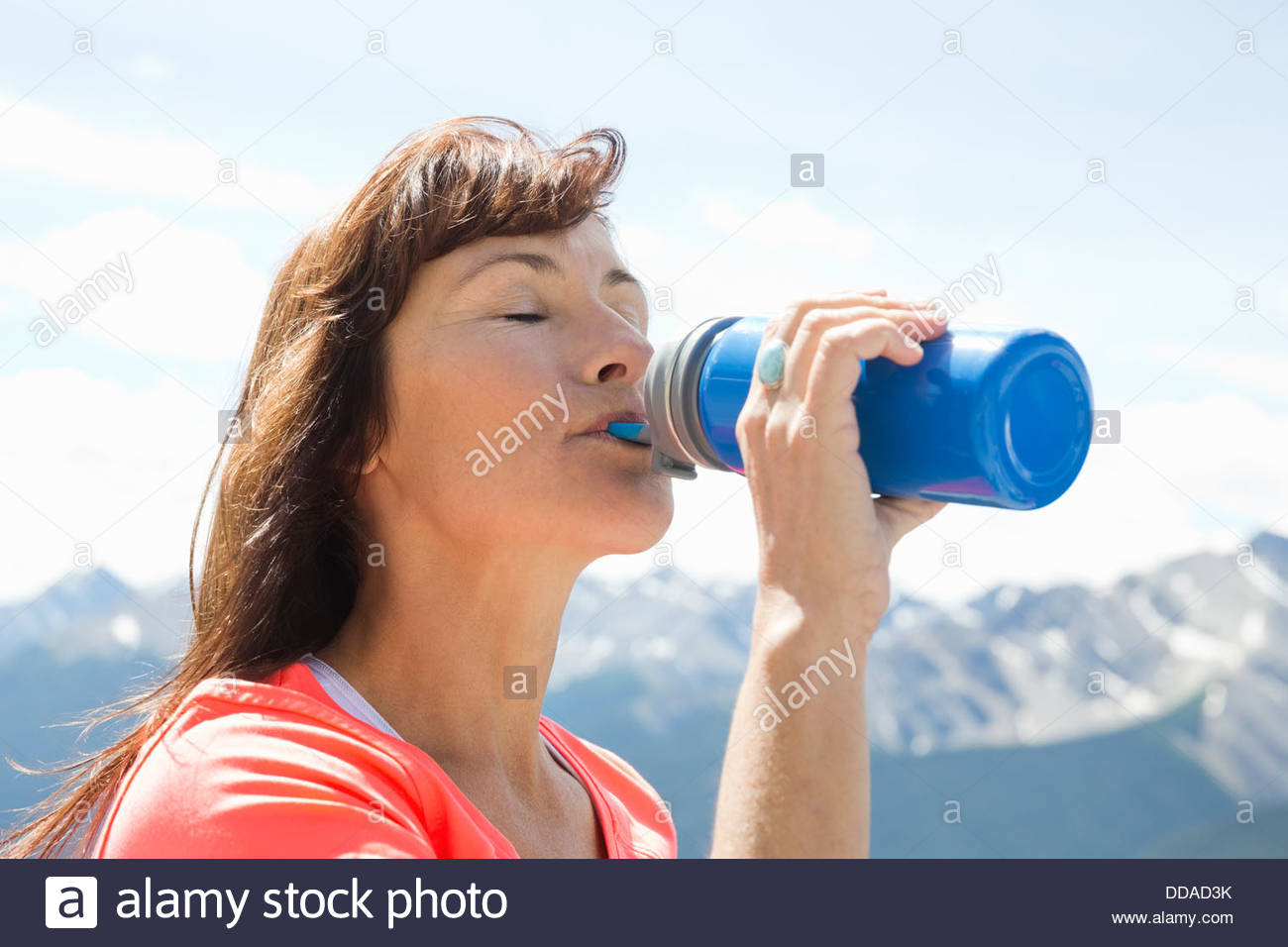 Mature woman drinking water after exercising outdoors Stock Photo Alamy