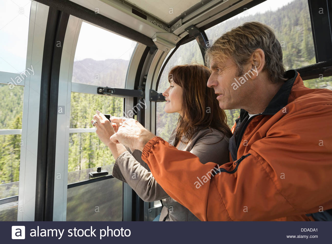 Mature couple photographing view on gondola Stock Photo Alamy