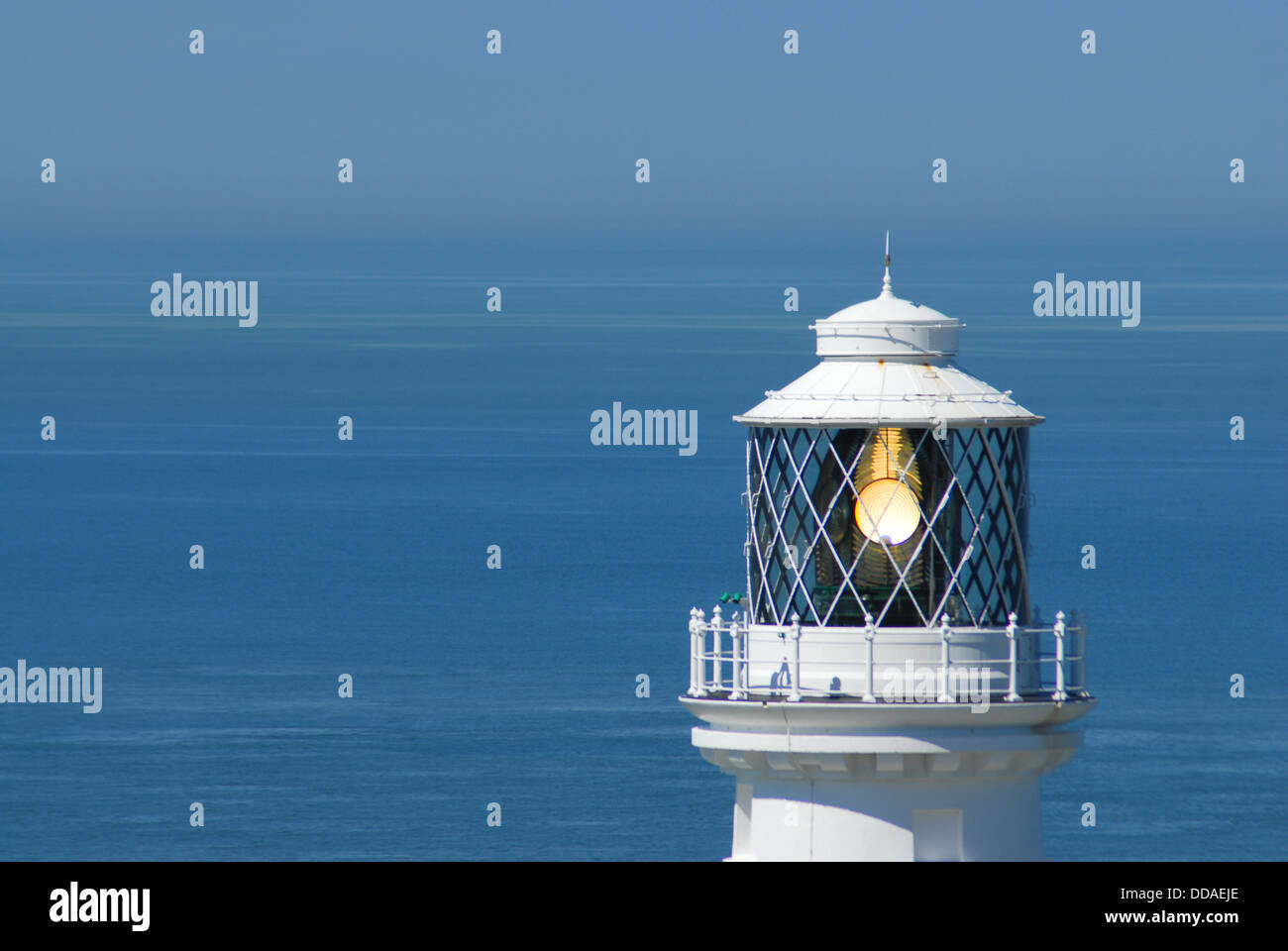 Top portion of the South Stack lighthouse on Anglesey in Wales. Shot taken at eye level to the light, fresnel glass visible Stock Photo