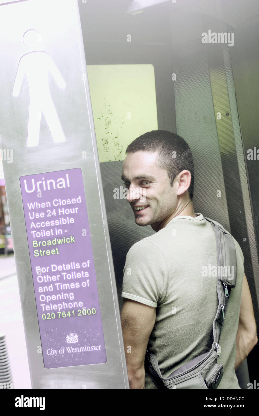 Man using urinal Stock Photo Alamy