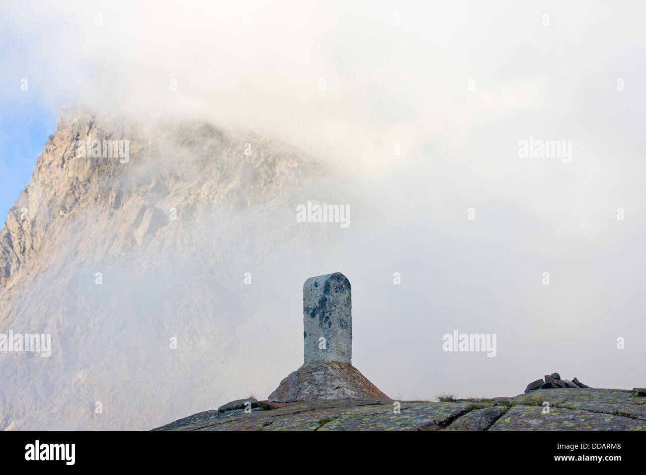 Marking of the border on a pass between Switzerland and Italy in the mountains Stock Photo