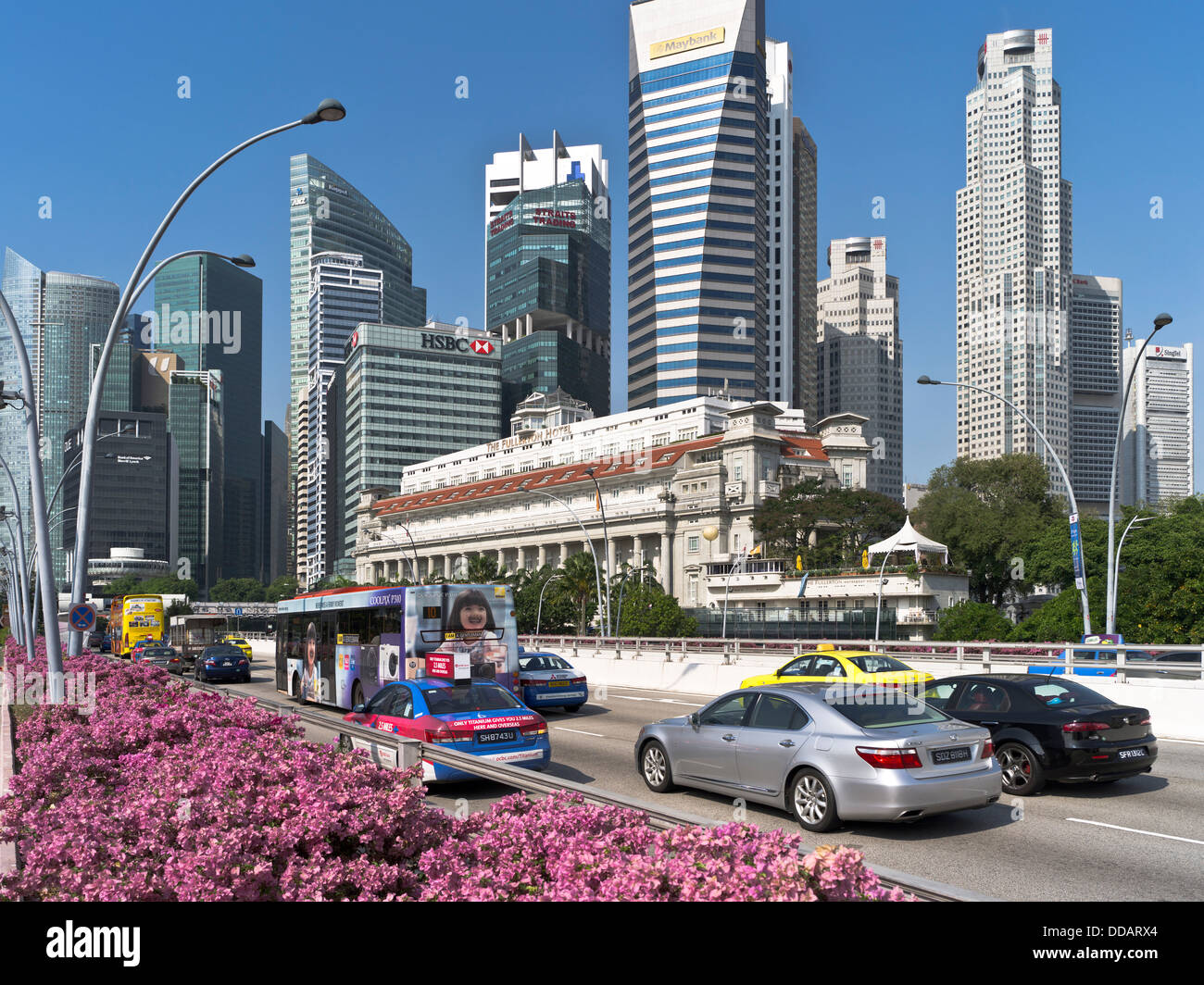 dh Fullerton Hotel DOWNTOWN CORE SINGAPORE Road car traffic flowers Maybank Tower city skyscrapers hotels old new Stock Photo