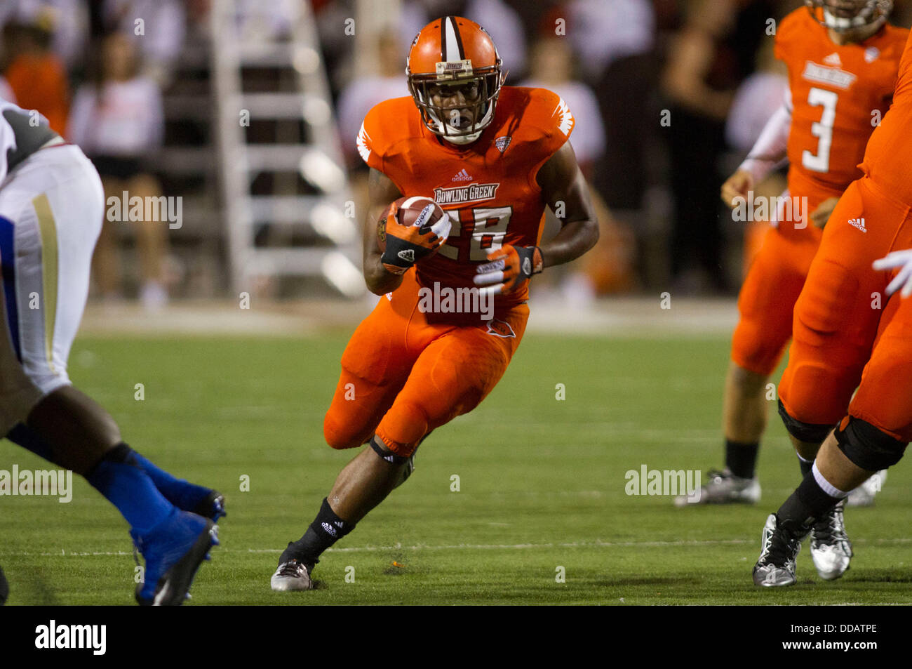 Aug 29, 2013 - Bowling Green, Ohio, U.S. - Bowling Green Falcons running back Fred Coppet #28 runs through a hole during the NCAA football game between the Tulsa Golden Hurricane and the Bowling Green Falcons at Doyt Perry Stadium. Bowling Green won 34-7. Stock Photo