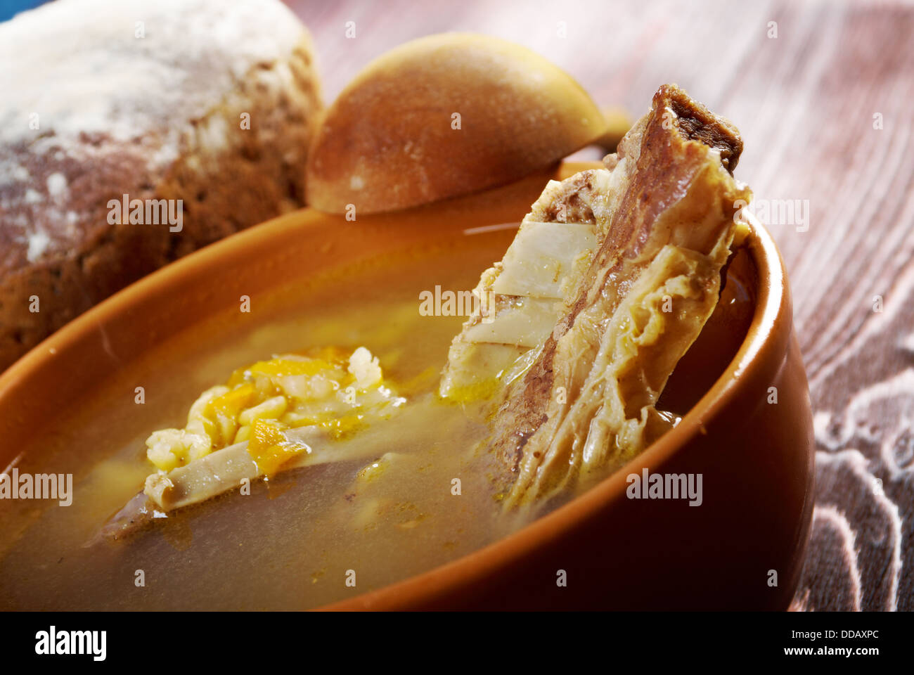 Pea soup with beef ribs and farmhouse bread,edible greens .farmhouse kitchen Stock Photo