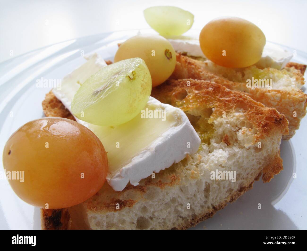 Toasted bread with brie and grapes Stock Photo Alamy