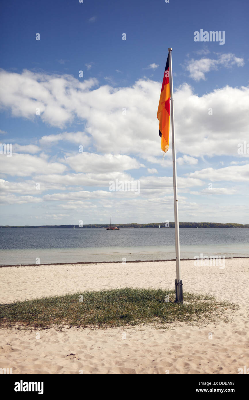 Eckernfoerde, Germany, Eckernfoerder view over the bay with Germany flag on the beach Stock Photo