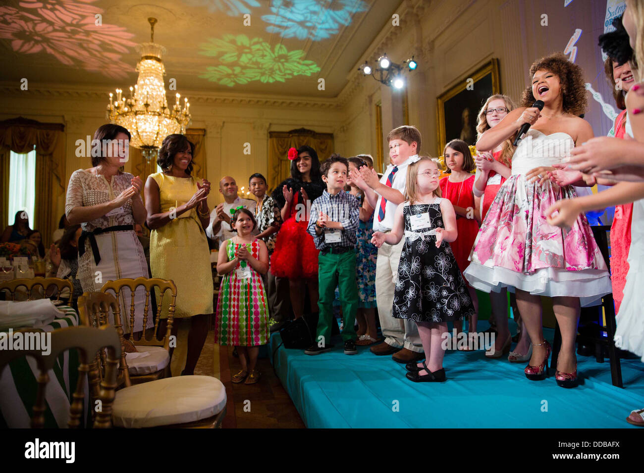 US First Lady Michelle Obama dances as Rachel Crow performs during the Kids' State Dinner in the East Room of the White House July 9, 2013 in Washington, DC. Stock Photo
