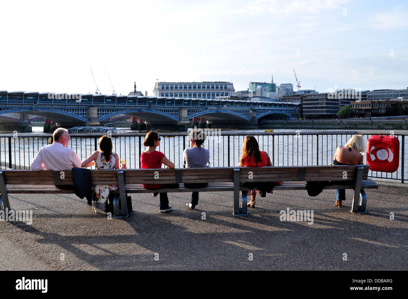Office workers enjoy the evening sunshine in London, UK Stock Photo