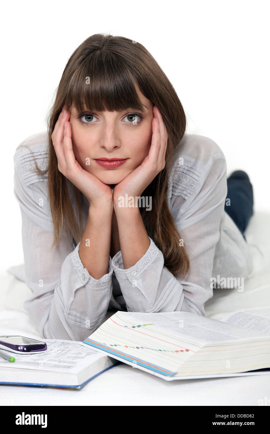 Woman lying down with reference books Stock Photo Alamy